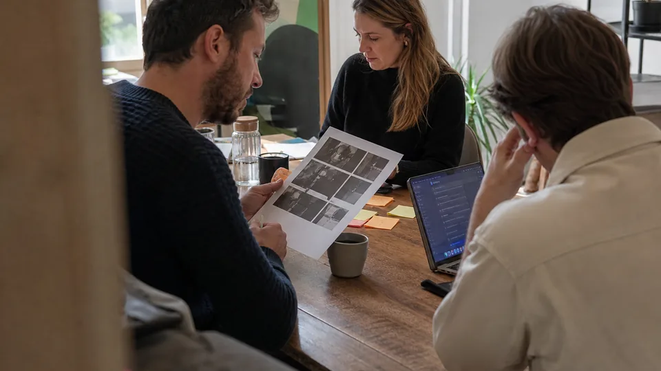 Agency team reviewing a shortlist of AI visibility tools at a meeting table