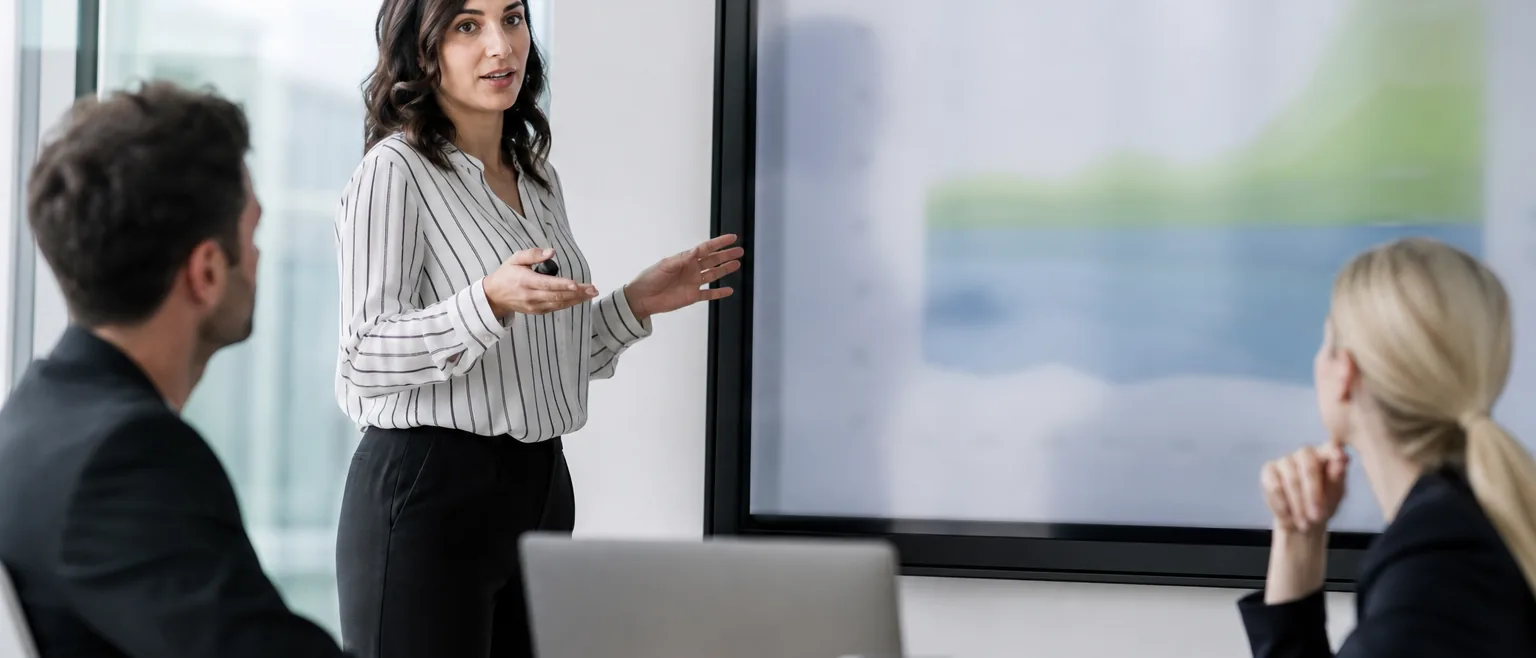 Communications director presenting media coverage analysis to executives